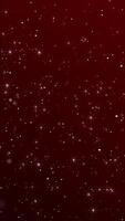 Shiny glittering red Christmas background with white twinkling stars and swirling snow particles. Full HD and looping luxury festive vertical background animation. video
