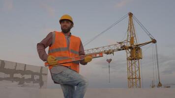 Funny construction worker dancing. Positive dance of builders in helmet. Construction engineer in builder uniform dancing on his work place video