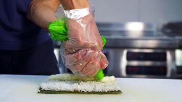 Making sushi at restaurant. The process of making sushi and rolls video