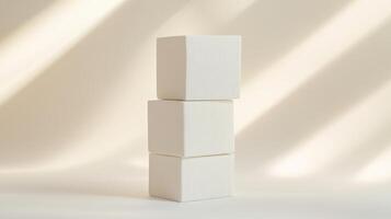 Three white cubes stacked on beige background with soft lighting photo