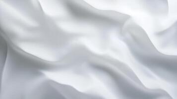 Smooth white fabric with gentle folds creating soft, flowing texture photo