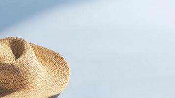 straw hat on light blue background, simple and minimalistic summer vibe photo