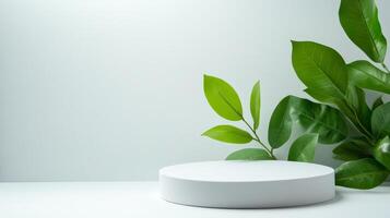 Minimalistic white podium with green leaves on light background photo