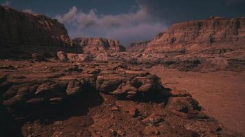 Vast rocky landscape with towering cliffs under a cloudy sky in daylight video
