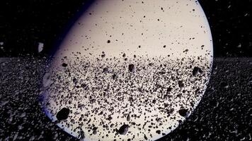 Saturn surrounded by rings and rocky debris captured in deep space video