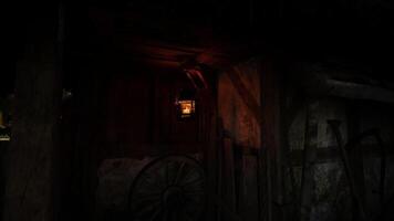 Lantern illuminating a rustic wooden cabin at dusk in a quiet rural setting video