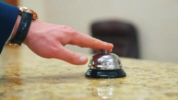 Service bell locating at reception. Customer ringing hotel reception service bell video