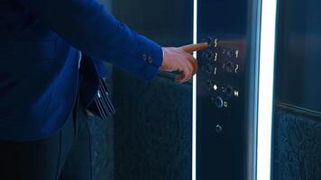 Man pressing elevator button. Traveling businessman with suitcase waiting for elevator in hotel video