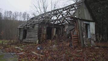 A dilapidated and neglected house displaying numerous clear signs of abandonment and nature reclaiming its space video