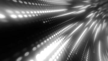 Abstract black-and-white dot pattern with blurred motion effect, creating a sense of depth and dynamic flow. Ideal for technology, science, and digital background video