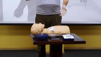 Emergency first aid CPR procedure. Demonstrating chest compressions on CPR doll in the class video