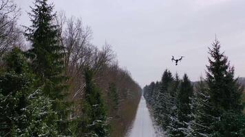 Drone with camera flying high above. Personal drone flying through the air in suburban atmosphere video