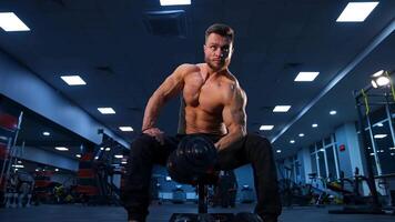 Athletic man doing exercise with dumbbell. Powerful bodybuilder doing the exercises with dumbbells video