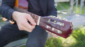 Hand Turns Wrench For Manual Tuning Of Classical Guitar In The Park video