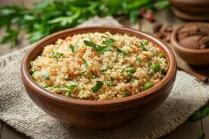 Bowl of delicious couscous with peas, herbs, and spices on rustic table photo