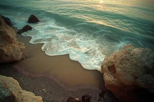 Ocean waves gently crashing on rocky beach at sunset photo