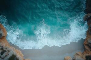 Turquoise ocean waves crashing on secluded sandy beach, aerial view photo
