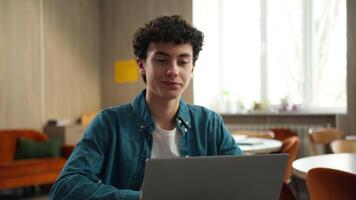 Happy satisfied Caucasian male boy guy student in school university academy finish end using laptop computer homework done complete internet e-learning studying online education technology knowledge video