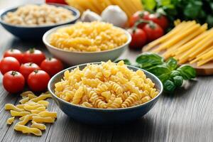 Bowls of uncooked pasta with tomatoes, garlic, and basil on rustic table photo