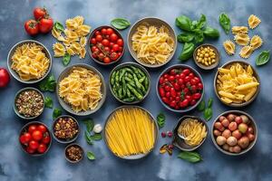 Variety of italian pasta, vegetables and spices creating a colorful culinary scene photo