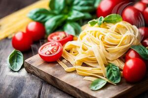 Tagliatelle pasta with tomatoes and basil on wooden board photo