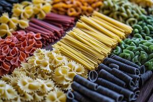 Colorful pasta variety displayed on wooden table photo