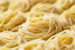 Delicious italian spaghetti forming appealing round nests ready to be cooked photo