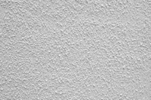 Gray rough plaster. Abstract building background. Surface of wall of building. photo