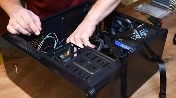 Time lapse technician opens and assemble mini PC tower with brand new hardware. Man hands install and fix computer motherboard back plate with wrench. Computer maintenance. Odessa, Ukraine, 12 26 2020 video