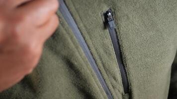 Man zipper on a jacket in cold autumn day. video