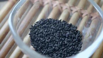 slow motion of dropping Black Seeds in a container video