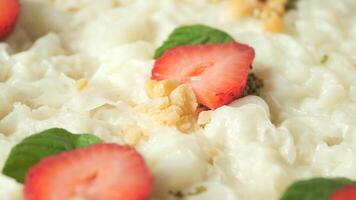 Enjoy a Creamy Dessert with Fresh Strawberries and a Mint Garnish video