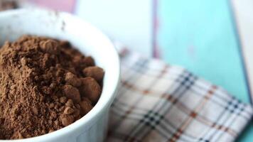 coco powder in a bowl on table, video