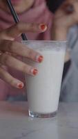 A Refreshing White Beverage Served in a Glass with an Attached Straw video
