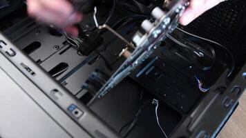 Male hands connect cables to motherboard mini-ITX ASUS with CPU Intel Core i7 Processor into PC tower Zalman. Computer hardware assembling for mining and gaming. Odessa, Ukraine, 04 11 2021 video