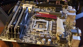 Closeup of modern PC motherboard hardware with empty space for CPU. Male finger touches fixer for CPU. Computer technology background. Odessa, Ukraine 12 13 2020 video