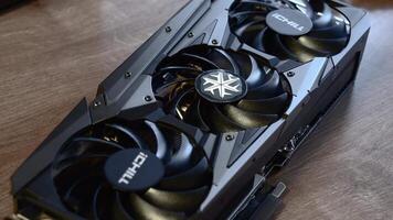 Powerful brand new NVidia GeForce RTX 3080 graphics card unboxed before installing into gaming PC. Fingers touch and rotate card cooling system fan. Computer hardware. Odessa, Ukraine 12 13 2020 video
