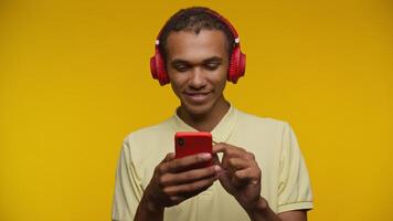 Surprised Man Reading Good News on Smartphone on Yellow Background video