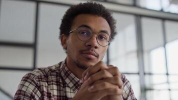 Thoughtful Man with Hands Folded in Modern Workspace video