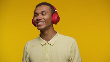 Young Man Smiling with Eyes Closed, Listening to Music on Headphones video