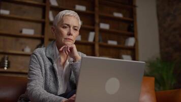 Senior Woman in Contemplation Working on Laptop in Office video