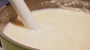 Smooth creamy mixture being blended in a bowl for culinary preparation video
