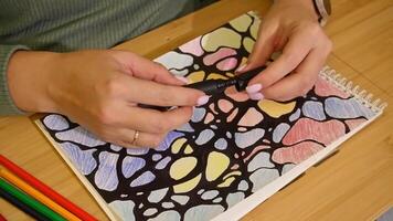 Hands close the cap of the black marker, after creating abstract art video
