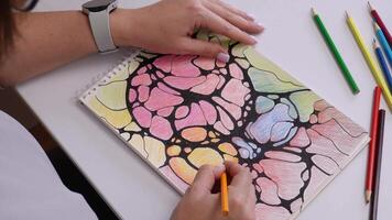Hand coloring abstract art pattern with pencils on sketchbook video