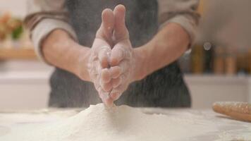 A person is sprinkling flour on a table video