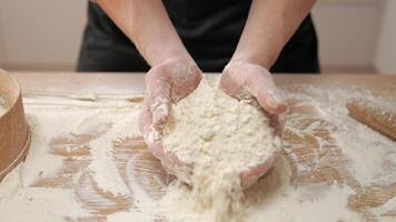 A person is holding a bowl of flour on a table video