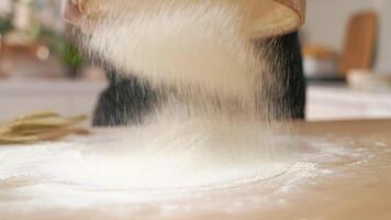 A person sprinkling flour on a table video