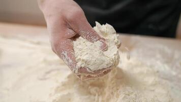 A person is kneading dough on a table video
