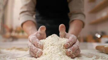 A person is holding a bowl of flour on a counter video