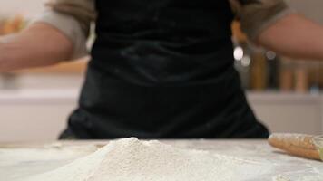 A person is holding a bowl of flour on a table video